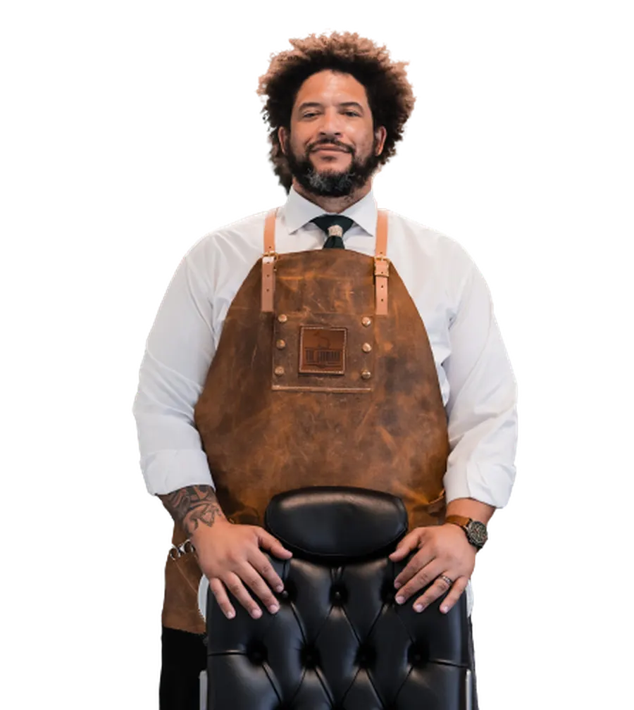 Elliott Chester standing behind a barber chair