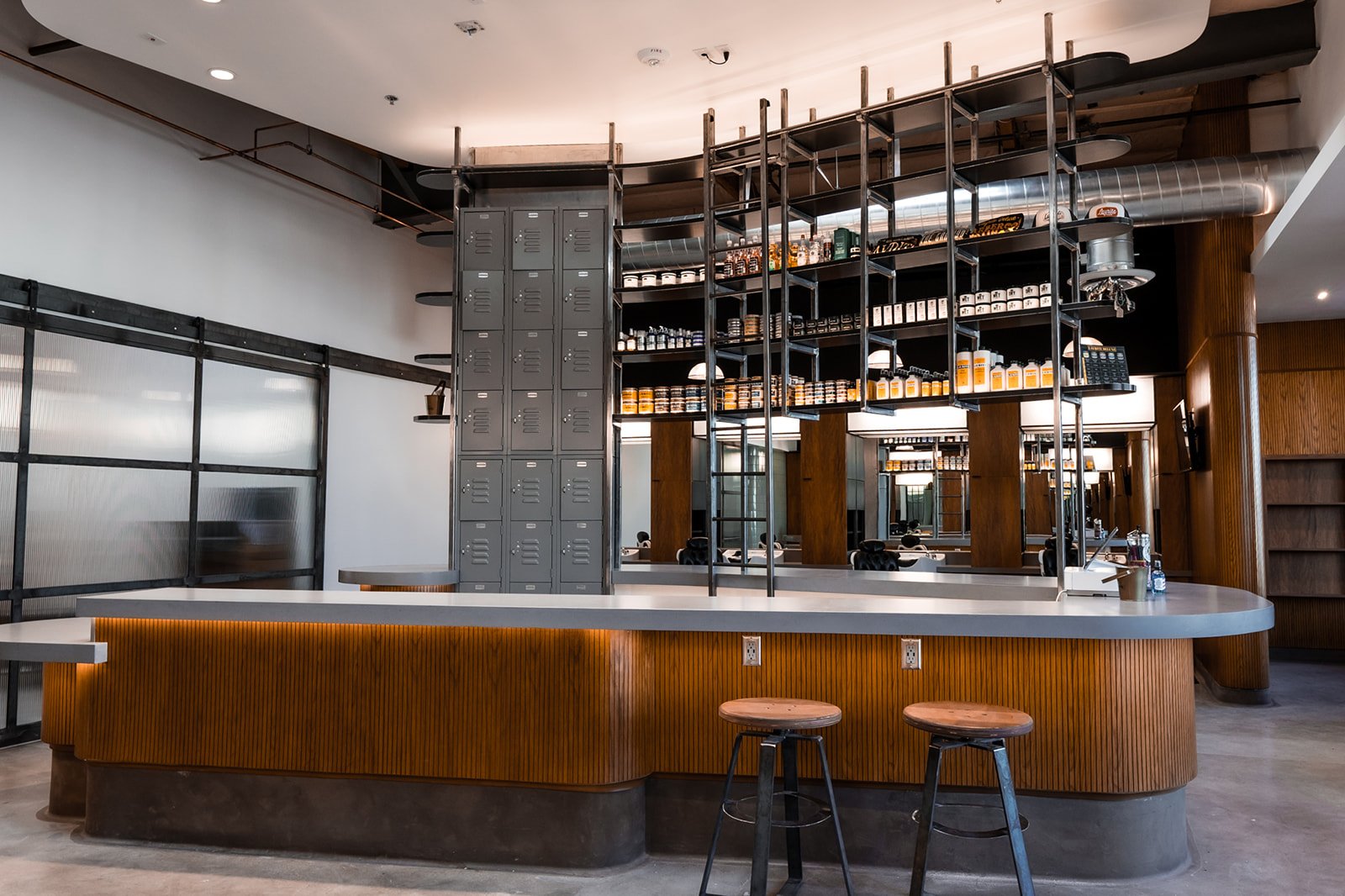 The bar at The Garrison with stools and shelves of grooming product behind it