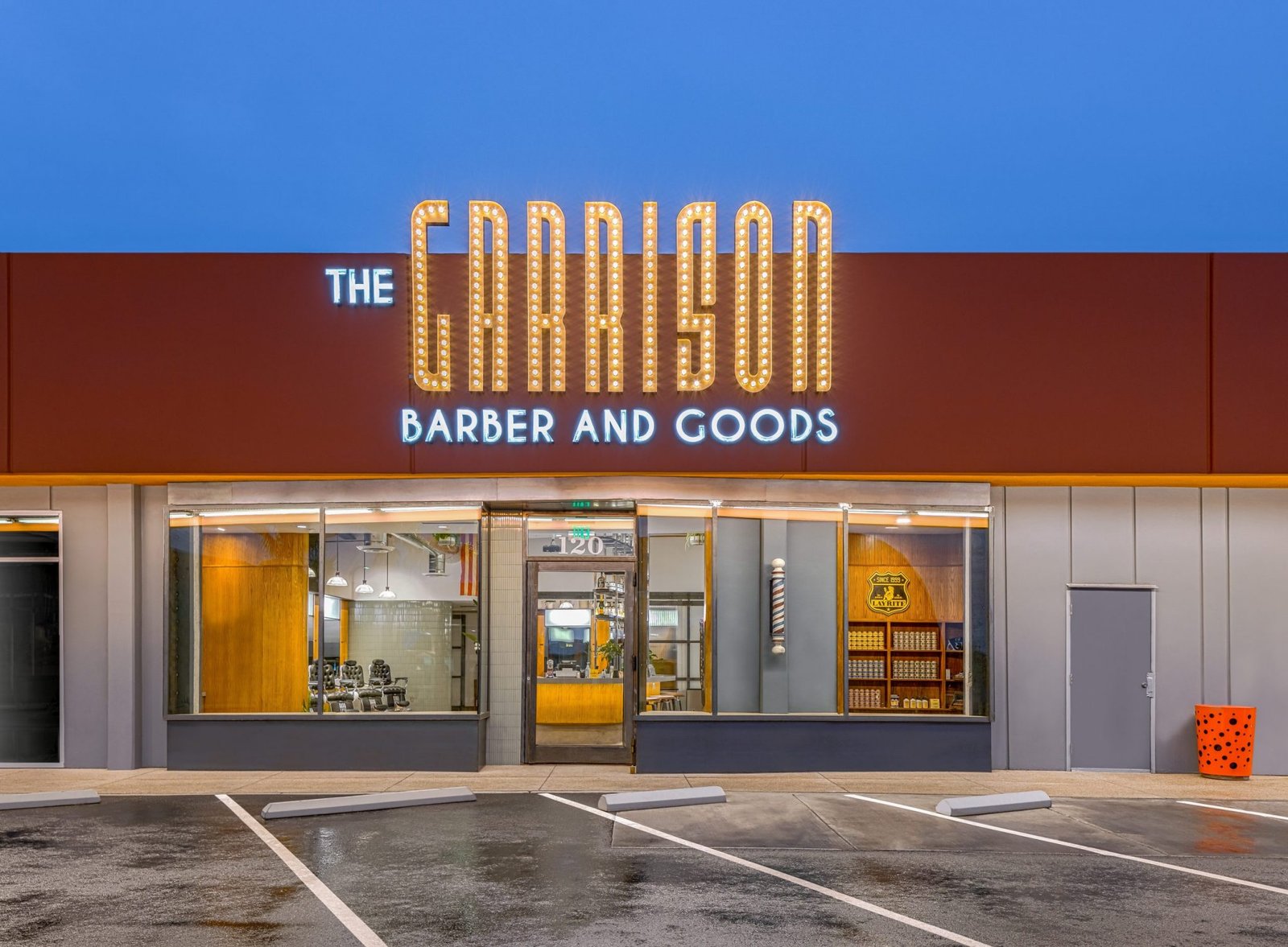 The lit Garrison Barber and Goods sign on the storefront on East Charleston Boulevard