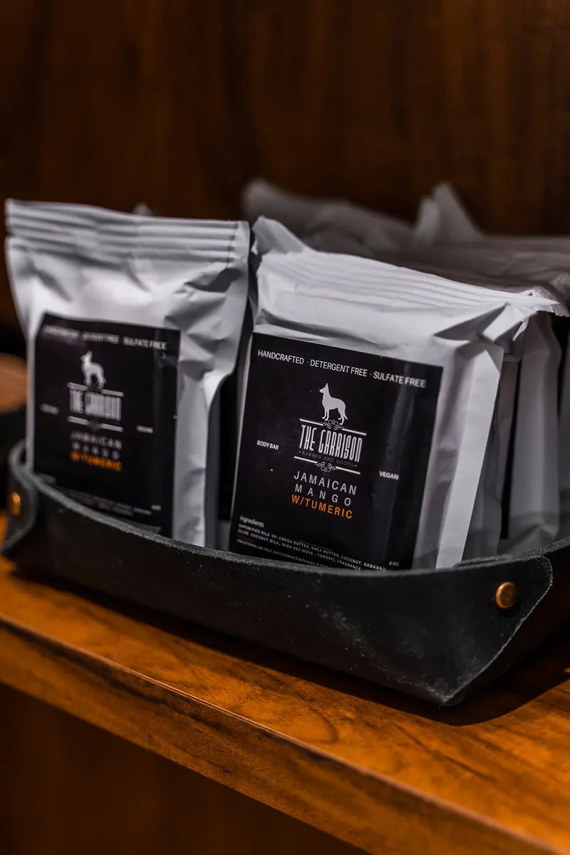 Two bags of The Garrison grooming product in a leather case