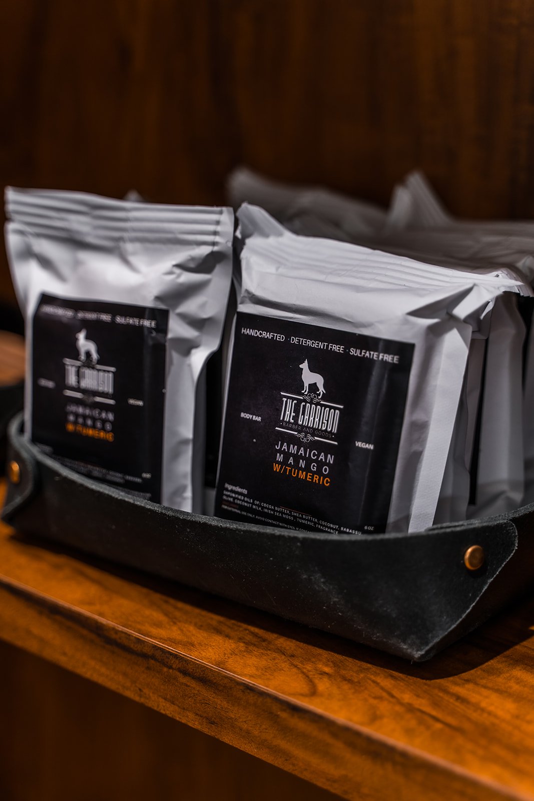 Two bags of The Garrison grooming product in a leather case